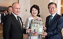 Vladimir Putin presented Moon Jae-in and his wife with a book about the State Hermitage Museum.