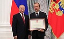 A letter of recognition for contribution to the development of Russia football and high athletic achievements is presented to Russia national football team coach Vladimir Panikov.