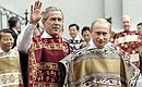 President Vladimir Putin and US President George W Bush wear Chilean ponchos as they arrive for an official APEC Leaders photo session at La Moneda palace. Photo: TASS