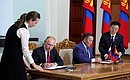 Signing documents following Russian-Mongolian talks.