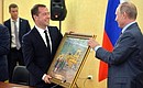 Vladimir Putin congratulated Dmitry Medvedev on his recent birthday and presented him with a painting – In the Workshop. Mr Medvedev turned 51 on September 14.
