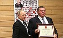 During a visit to the Turbostroitel Club, Vladimir Putin presented state awards to club athletes and former members. President of the Interregional Public Foundation for Promoting Physical Fitness and Sports Sambo Vasily Shestakov was presented with a Certificate of Honour of the President of the Russian Federation.