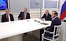Videoconference with Russian Aircraft Corporation MiG. With Defence Minister Sergei Shoigu (left), Deputy Prime Minister Dmitry Rogozin and Industry and Trade Minister Denis Manturov (right).