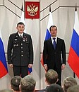 Dmitry Medvedev presents the Medal for Distinguished Service in Defending Public Order to Police Force officer Sergei Borodin.