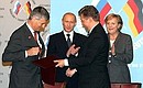 Signing joint documents following Russian-German intergovernmental consultations.