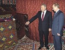 President Putin and Kazakh President Nursultan Nazarbayev looking at the inside of a yurt.