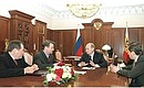 President Vladimir Putin meeting with Economic Development and Trade Minister German Gref and Tax Minister Gennady Bukayev (left), and Labour and Social Development Minister Alexander Pochinok (right).