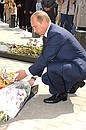 President Putin laying flowers at the graves of sailors who died aboard the Kursk nuclear-powered submarine.