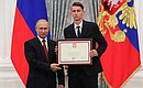 A letter of recognition for contribution to the development of Russia football and high athletic achievement is presented to Russia national football team player Ilya Kutepov.