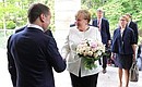 German Federal Chancellor Angela Merkel arrives for talks with President of Russia Vladimir Putin. With Prime Minister Dmitry Medvedev (left).