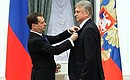 Dmitry Medvedev presents the Order for Services to the Fatherland, IV degree, to Vladimir Lutchenko, Merited Sports Master of the USSR.