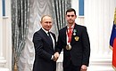 Presenting state decorations to winners of the 2020 Summer Paralympic Games in Tokyo. Maxim Shaburov, wheelchair fencing champion and silver medallist of the Paralympics, receives the Order of Friendship. Photo: RIA Novosti