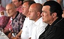 Actor Steven Seagal joins Vladimir Putin at a meeting with Russia’s Olympic judo team.