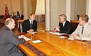 To the left of the President, Prime Minister Mikhail Fradkov, to the right, the Head of the Central Bank Sergei Ignat\'ev, and Minister for Finance Alexei Kudrin.