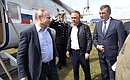 Vladimir Putin inspecting from a helicopter the areas damaged by the floods in late June 2019, with Deputy Prime Minister Vitaly Mutko, centre, and Presidential Plenipotentiary Envoy to the Siberian Federal District Sergei Menyailo.