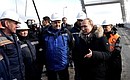 During the inspection of the completed road section of the Crimean Bridge. Speaking with construction workers.