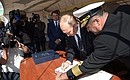 Vladimir Putin signed the distinguished visitors’ book during his tour of the Nadezhda tall ship.