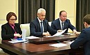 Before the meeting on economic issues. Chief of Staff of the Presidential Executive Office Anton Vaino, right, Presidential Aide Andrei Belousov and Central Bank Governor Elvira Nabiullina.