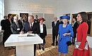 Vladimir Putin signs the distinguished visitors' book at the Hermitage on the Amstel Museum.