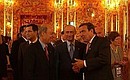 President Putin with Greek Prime Minister Konstantinos Simitis and German Chancellor Gerhard Schroeder (right) in the Amber Room. In the background, left — European Commission President Romano Prodi.