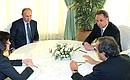 В ходе встречи с президентом УЕФА Мишелем Платини. Второй справа – Министр спорта Виталий Мутко.
