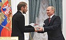 Vladimir Putin presents the main prize – the Big Crystal Pelican – to Alexander Demakhin, who teaches world art.