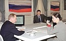 Vladimir Putin with Yekaterina Andreyeva and Sergei Brilev, TV presenters of the ORT and RTR TV channels, during a live televised question-and-answer session.