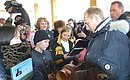 President Putin visiting a school in the village of Novaya Murya, where pupils gave him a choron wooden cup, a symbol of Yakutia.