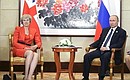 With Prime Minister of Great Britain Theresa May. Photo: TASS