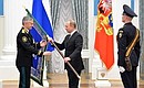 Vladimir Putin presents the banner of the Federal Bailiff Service to its Director – Chief Bailiff of the Russian Federation Artur Parfenchikov.