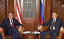 President Vladimir Putin in conversation with President George Bush of the United States.