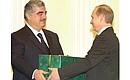 President Putin and Lebanese Prime Minister Rafik Hariri. Mr Putin congratulated Mr Hariri on his birthday and gave him a present.