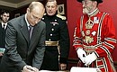 Vladimir Putin making an entry in the honoured guests book during a visit to the Tower of London. 