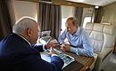 With Head of the Republic of Khakassia Viktor Zimin while flying over districts affected by wildfires.