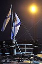 Hoisting order-bearing Russian naval ensign, St Andrew's flag, aboard nuclear-powered missile cruiser Pyotr Veliky.