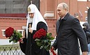 Vladimir Putin laid flowers at monument to Kuzma Minin and Dmitry Pozharsky on Red Square. With Patriarch Kirill of Moscow and All Russia. Photo: TASS