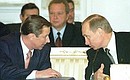 President Putin with Defence Minister Sergei Ivanov at a meeting of the CIS Heads of State Council.