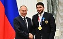 The ceremony for presenting state awards to the winners of the XXXII Olympics in Tokyo. Champion of the XXXII Olympics in freestyle wrestling in the under 97 kg weight category Abdularashid Sadulaev is presented with the Order of Honour. Photo: RIA Novosti