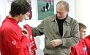 The Russian junior national football team\'s players gave the President a team shirt with their autographs on it.