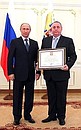 Presenting state decorations. Alexander Osiyev, president of the Karelian republican public organisation for immortalising the memory of those who fell defending the Fatherland, Union of Search Brigades of Karelia, receives an honorary certificate from the President.
