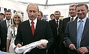 M. GROMOV FLIGHT RESEARCH INSTITUTE, ZHUKOVSKY AIR BASE, MOSCOW REGION. 8th International Aviation and Space Salon MAKS-2007. At the children\'s stand with an exhibition of model airplanes made by children. A participant from Kazakhstan gave Vladimir Putin the model airplane she had made.